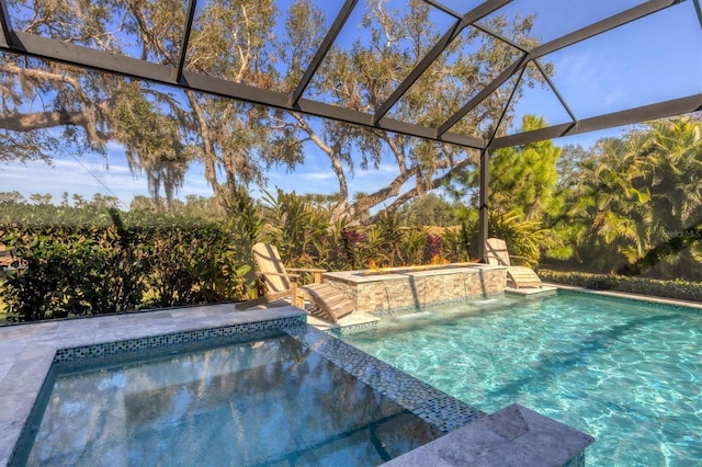 view of pool featuring an in ground hot tub, pool water feature, and glass enclosure