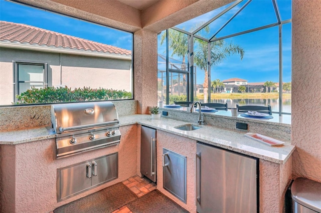 view of patio / terrace featuring sink, a lanai, a water view, area for grilling, and grilling area