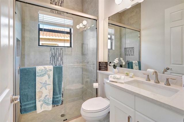 bathroom featuring walk in shower, vanity, and toilet