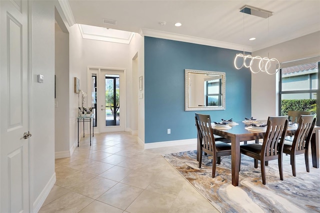 tiled dining room featuring ornamental molding