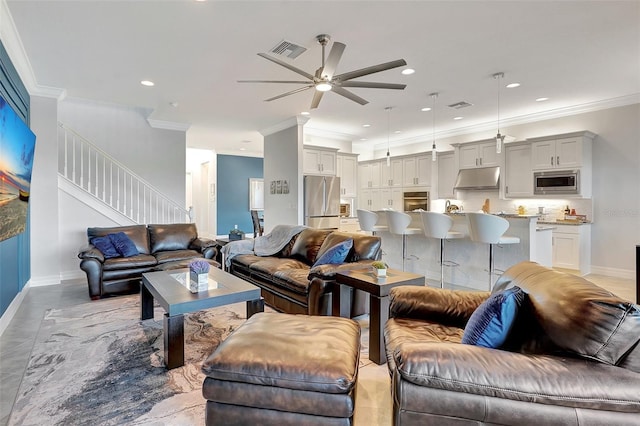 living room with ornamental molding and ceiling fan