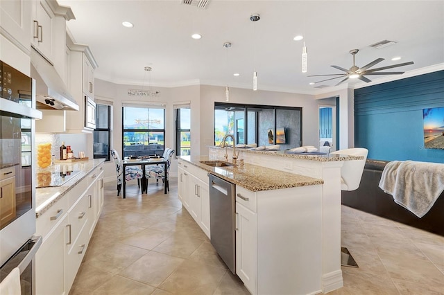 kitchen with a spacious island, sink, white cabinetry, hanging light fixtures, and stainless steel dishwasher