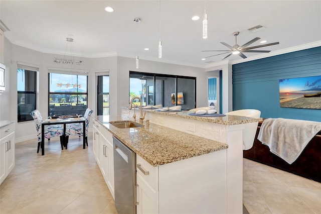 kitchen with a kitchen island with sink, pendant lighting, white cabinets, and appliances with stainless steel finishes