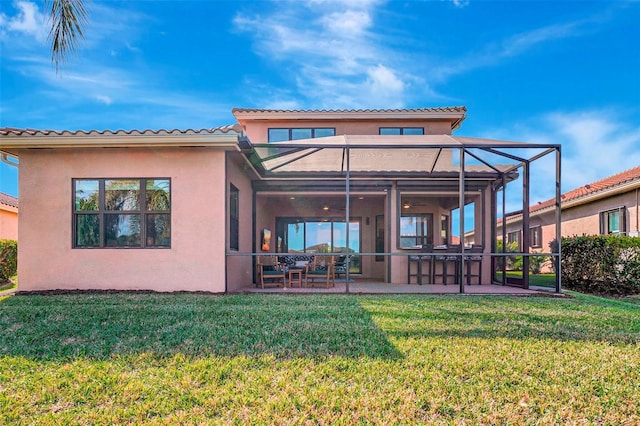 rear view of property featuring a yard, a lanai, and a patio