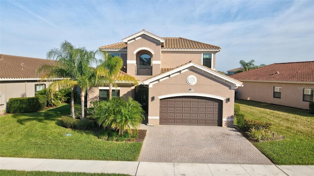 mediterranean / spanish-style house with a garage and a front yard