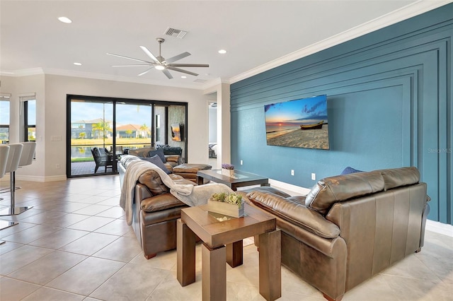 living room featuring crown molding, light tile patterned flooring, and ceiling fan