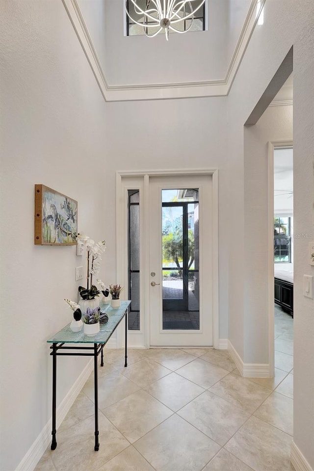 entryway featuring a high ceiling, a wealth of natural light, and light tile patterned floors