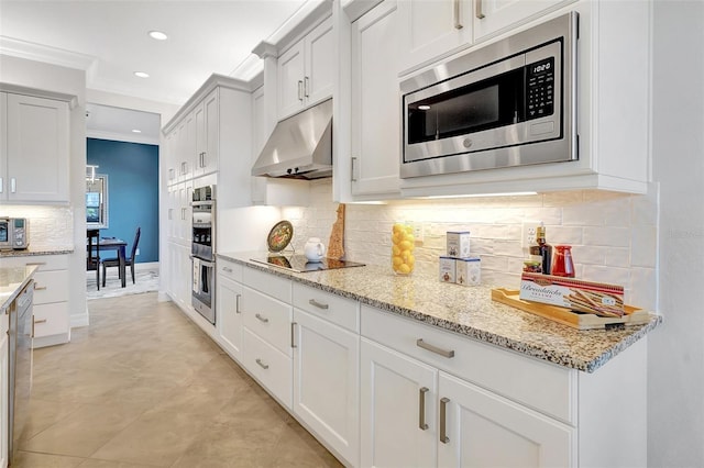 kitchen featuring crown molding, backsplash, stainless steel appliances, light stone counters, and white cabinets