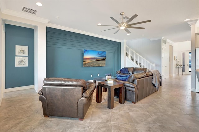 living room with light tile patterned floors, ornamental molding, and ceiling fan