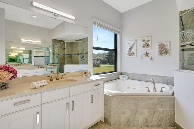 bathroom with vanity and independent shower and bath