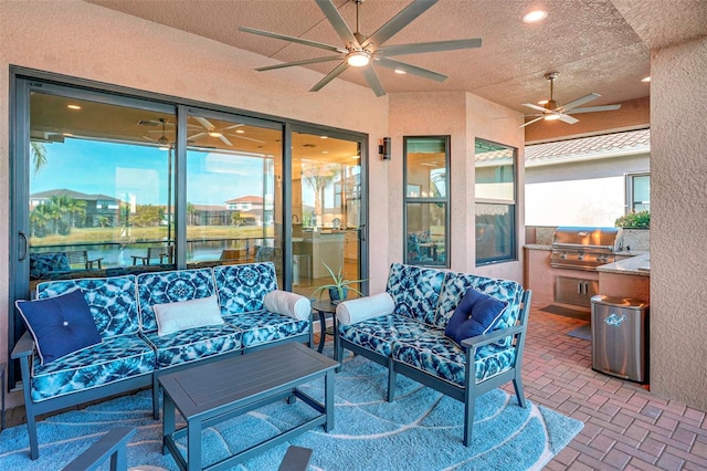 view of patio / terrace with outdoor lounge area, exterior kitchen, ceiling fan, grilling area, and a water view