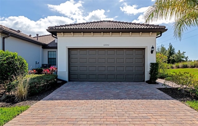 garage with decorative driveway