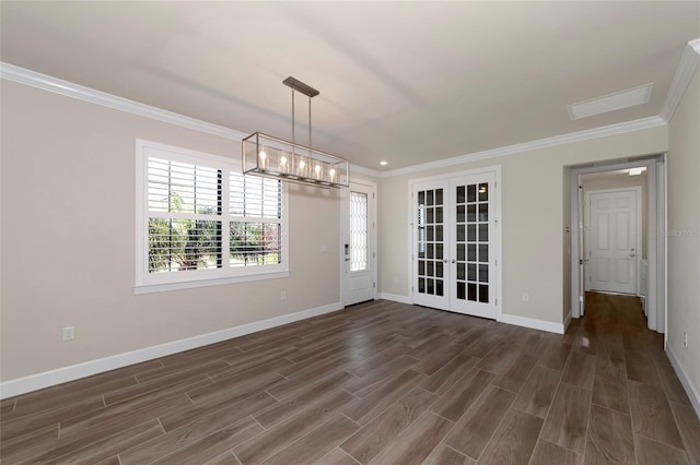 unfurnished dining area featuring french doors, baseboards, dark wood-type flooring, and crown molding