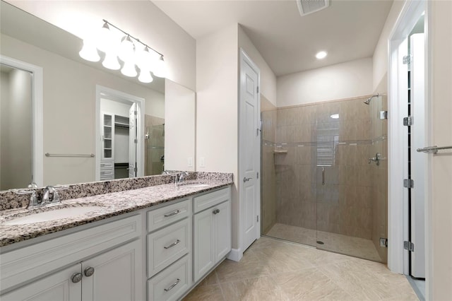 full bathroom with a shower stall, visible vents, and a sink