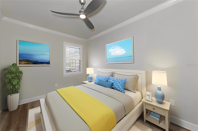 bedroom with baseboards, wood finished floors, ornamental molding, and a ceiling fan