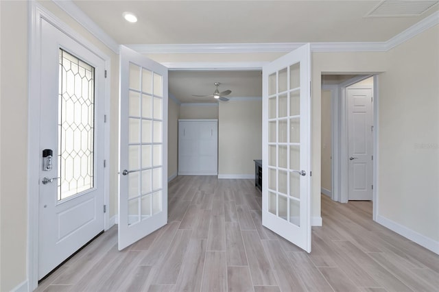 entryway featuring ornamental molding, a wealth of natural light, light wood-type flooring, and french doors