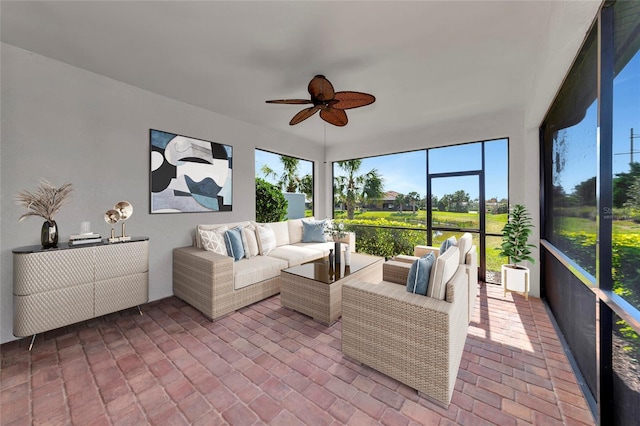 sunroom / solarium featuring ceiling fan