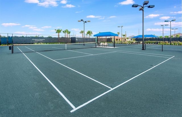 view of tennis court featuring fence