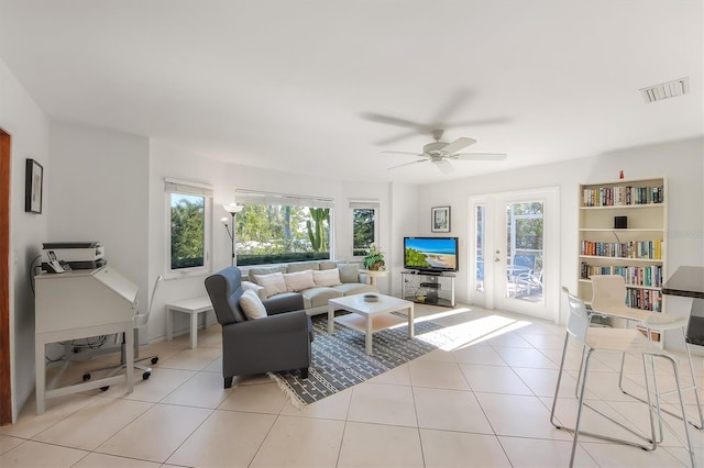 living room with ceiling fan and light tile patterned floors