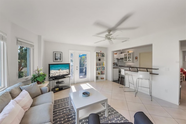 tiled living room with ceiling fan