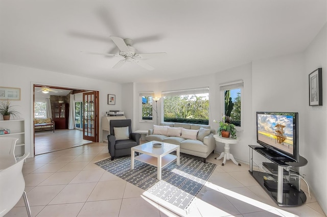 tiled living room with french doors and ceiling fan