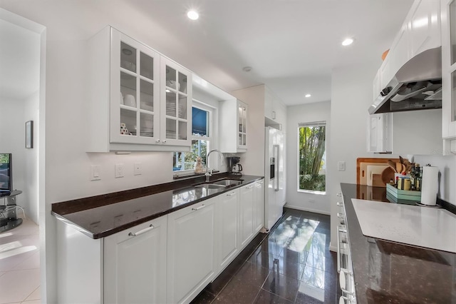 kitchen featuring white cabinetry, sink, a wealth of natural light, and high end white fridge