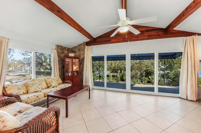 tiled living room with ceiling fan and vaulted ceiling with beams