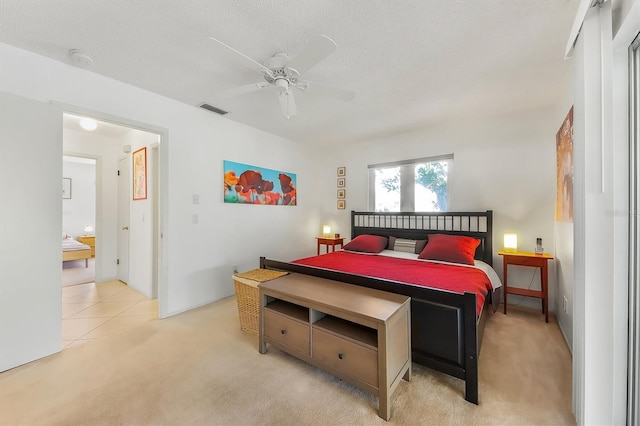 bedroom with light carpet, a textured ceiling, and ceiling fan