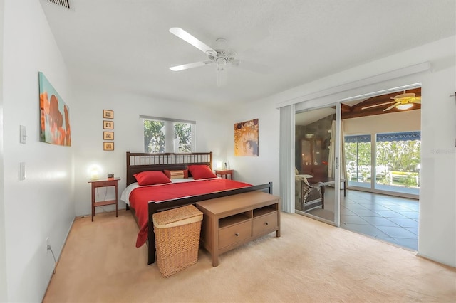 bedroom featuring ceiling fan, multiple windows, access to exterior, and light carpet