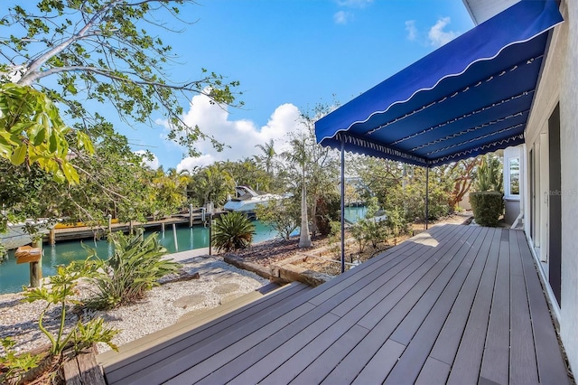 wooden terrace featuring a water view