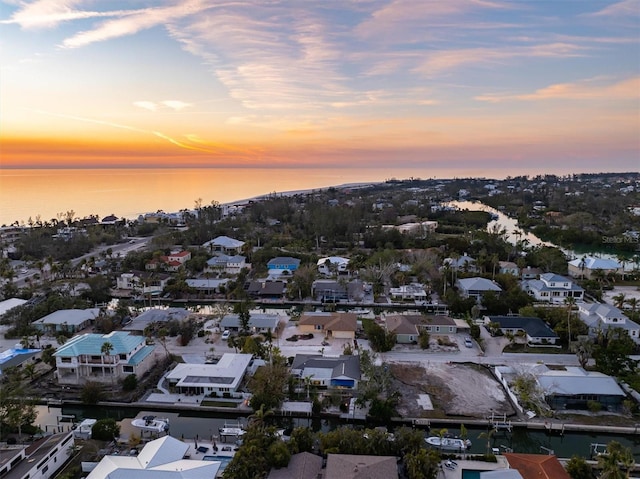 aerial view at dusk with a water view