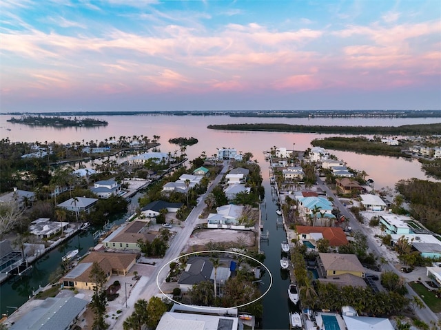 aerial view at dusk with a water view