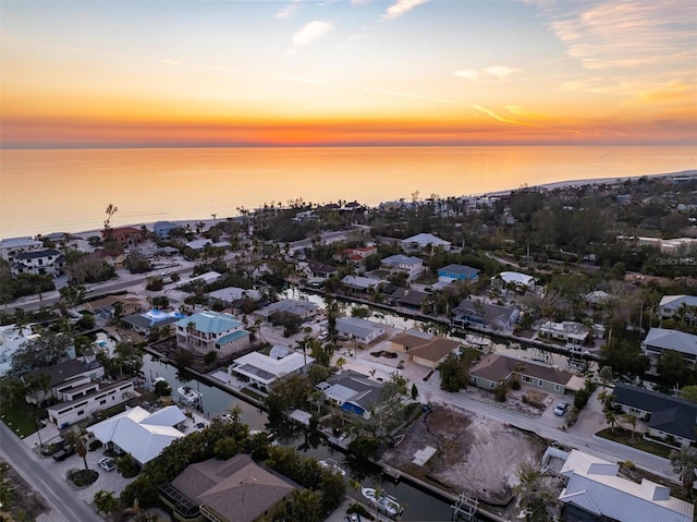 aerial view at dusk with a water view