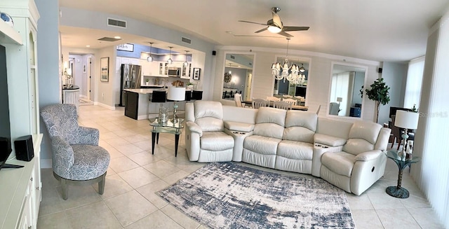 living room featuring ceiling fan with notable chandelier and light tile patterned flooring