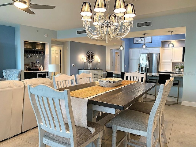 tiled dining room featuring ceiling fan with notable chandelier