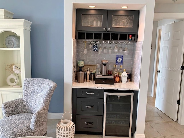 bar with beverage cooler, decorative backsplash, and light tile patterned floors