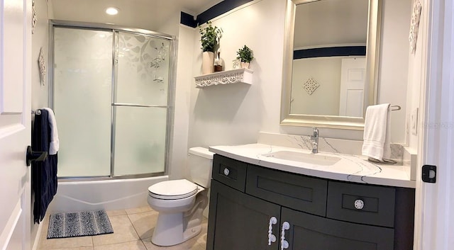 full bathroom featuring vanity, tile patterned floors, toilet, and combined bath / shower with glass door