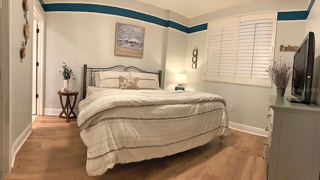 bedroom with hardwood / wood-style flooring