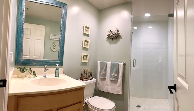 bathroom with vanity, toilet, and an enclosed shower