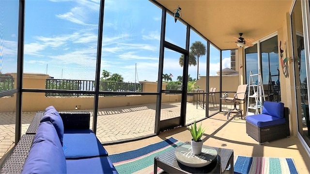 sunroom / solarium with ceiling fan and a healthy amount of sunlight