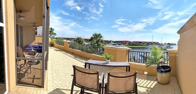 balcony featuring a water view and an outdoor bar