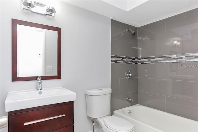 full bathroom with vanity, tiled shower / bath, and toilet