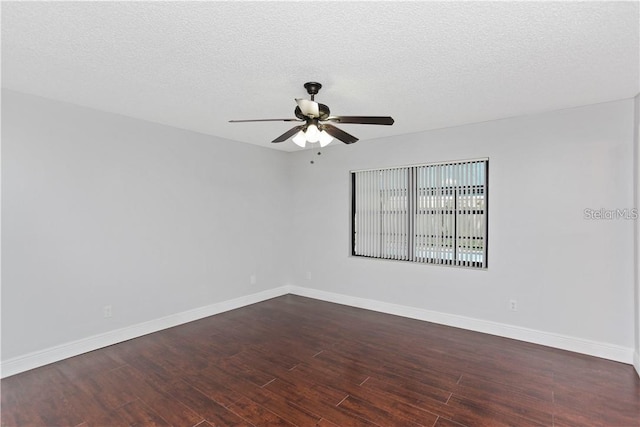 empty room featuring ceiling fan, a textured ceiling, and dark hardwood / wood-style flooring