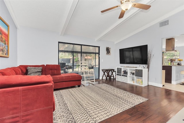 living room featuring hardwood / wood-style floors, a textured ceiling, lofted ceiling with beams, and ceiling fan