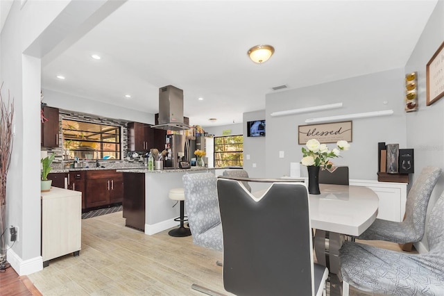 dining area with light hardwood / wood-style flooring