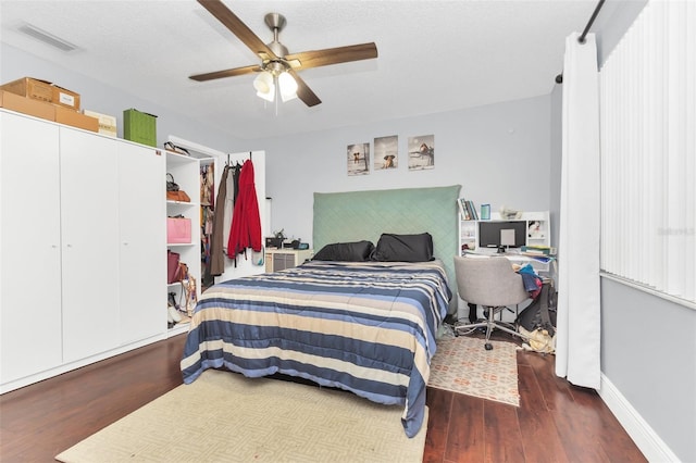 bedroom with dark wood-type flooring and ceiling fan