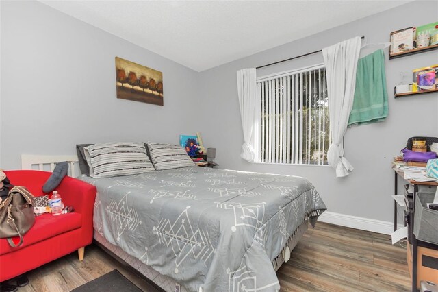 bedroom with hardwood / wood-style floors