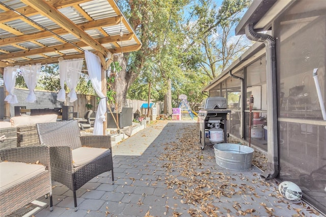 view of patio / terrace featuring an outdoor living space, a grill, and a playground