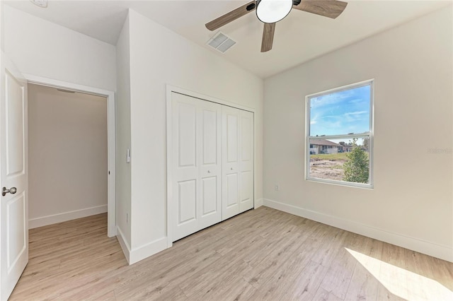 unfurnished bedroom featuring a closet, ceiling fan, and light hardwood / wood-style flooring