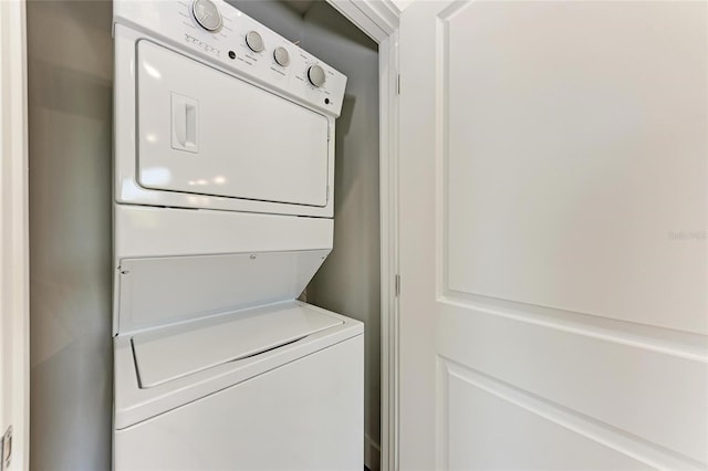 clothes washing area featuring stacked washer and dryer